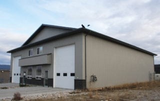 straight wall steel building with mezzanine office and stone facade knee wall