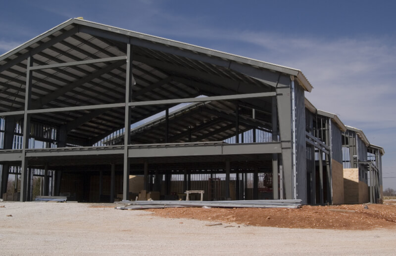 photo of large church under construction with steel structure fully erected