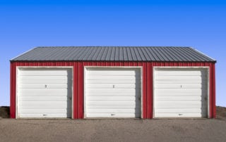 photo of 3 car metal garage with overhead doors