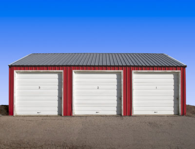 photo of 3 car metal garage with overhead doors