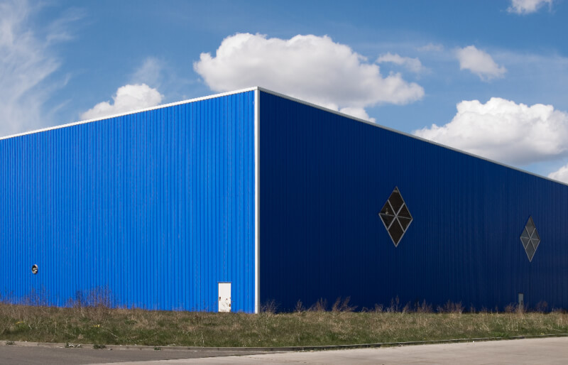 50 foot tall metal building with blue siding and diamond shaped windows