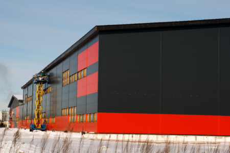 large metal building with black and red colour insulated metal panels