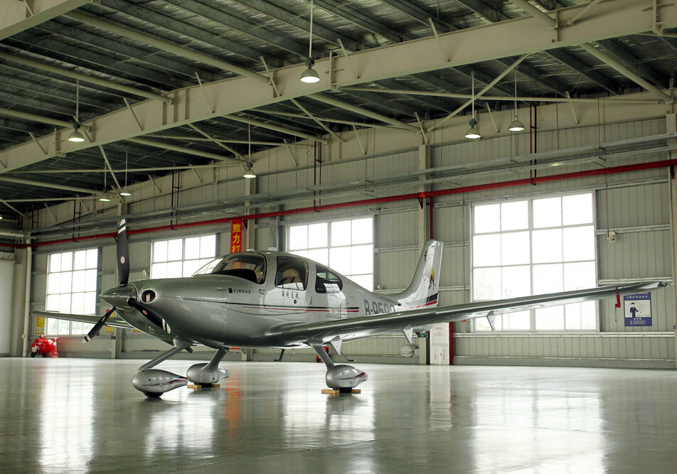low wing prop powered personal aircraft in a steel building aircraft hangar by Global Steel Buildings Canada