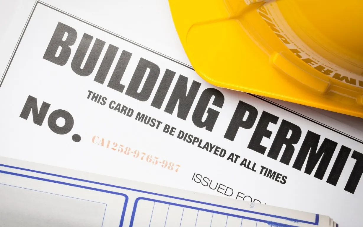 Building permit card with drawings and hard hat