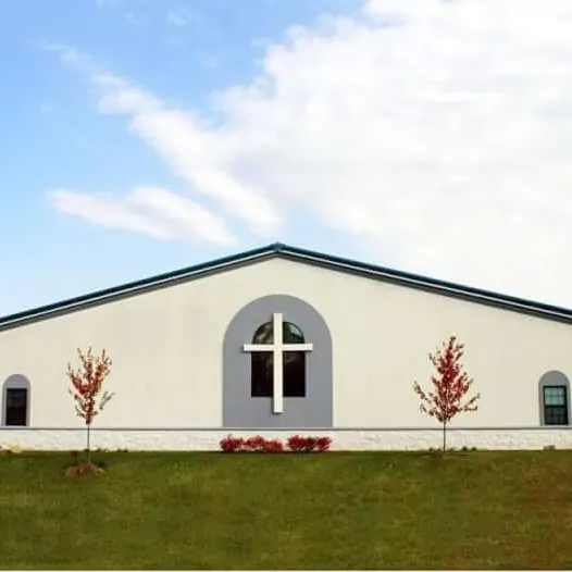 White steel church building with a cross window