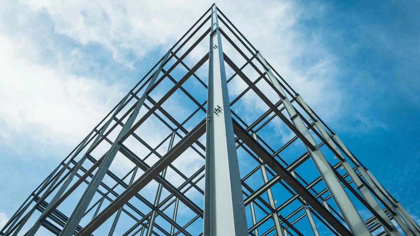 Steel building frame peak against a blue sky