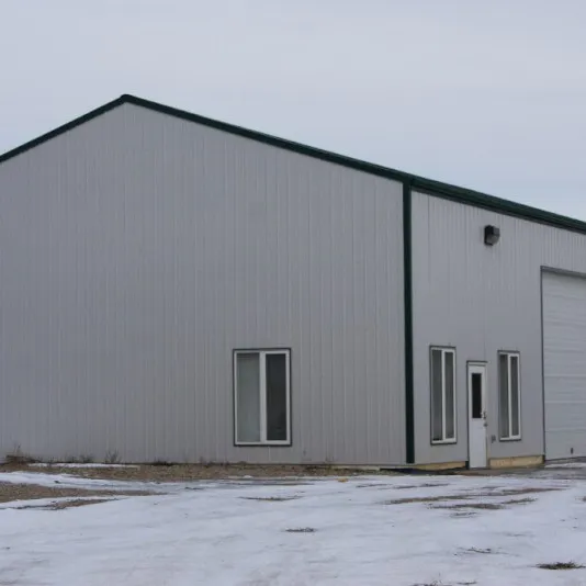 Grey steel building with tall overhead doors