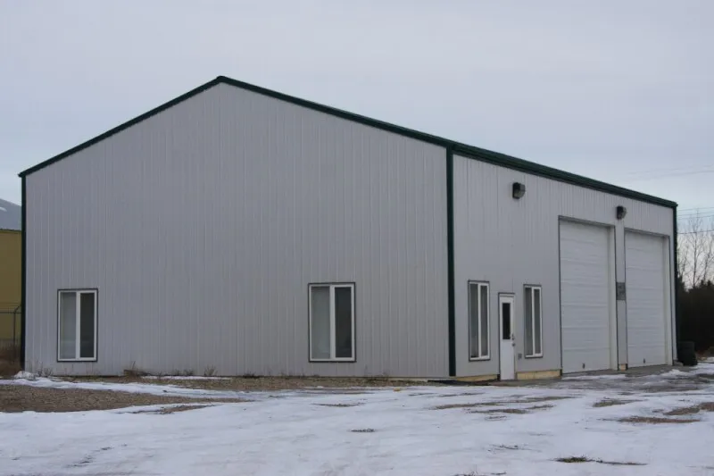Grey steel building with tall overhead doors